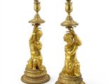pair of antique brass candlesticks with cherenshes and cherenshes on them