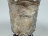 a silver cup that is sitting on a table