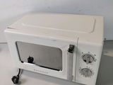 a white microwave sitting on a white counter top