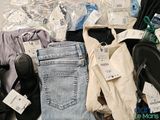 a pile of clothes and shoes that are on the floor
