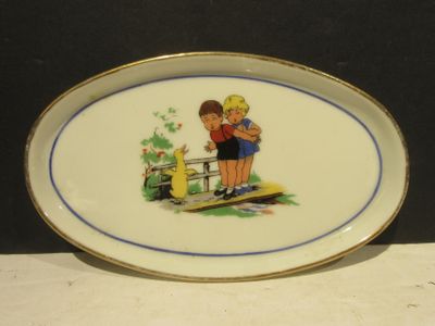 a plate with a picture of a boy and a girl on it