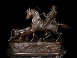 bronze statue of a man on a horse with a dog