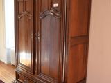 an image of a living room with a large wooden armoire