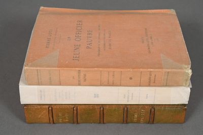 three books are stacked on top of each other on a table