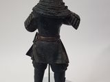 an image of a statue of a man with a hat and a sword