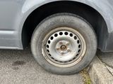 a car that has a flat tire on the side of the road