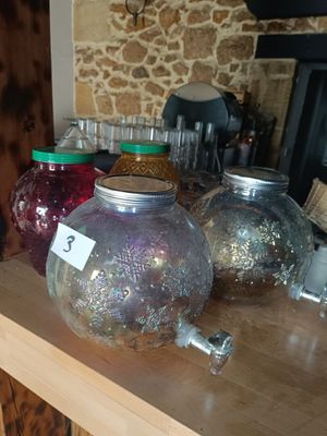 many jars on a table with jars on top of it
