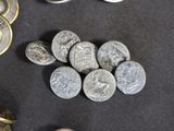 some coins are sitting on a table next to a pair of scissors
