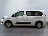 the white van is parked in a room with a gray floor