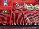 silverware in a red case on a table with silverware in it