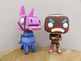two figurines of two different characters on a wooden table