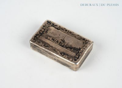an old silver box sitting on top of a white surface