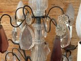a glass chandelier with a bunch of glass beads hanging from it