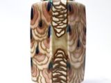 a small vase with a lid on a white surface