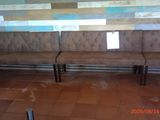 a picture of a bench in a room with tiled walls