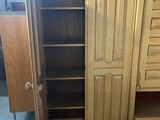 an image of a wooden cabinet with drawers and shelves