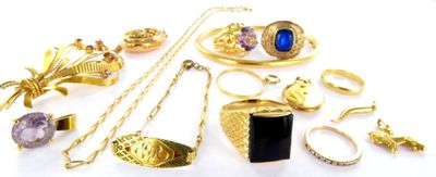 a lot of gold jewelry on a white surface