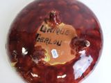 a picture of a brown and red vase with writing on it