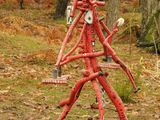 a red fire hydrant in the middle of the woods