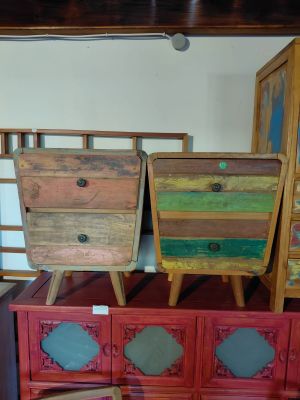 three wooden drawers stacked on top of each other in a room