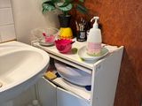a sink and a cabinet in a small bathroom