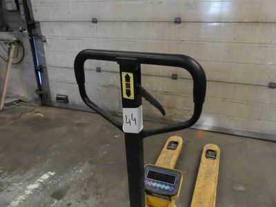 a forklift sitting next to a parking meter in a garage