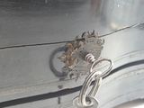 a close up of a metal door handle on a metal cabinet