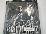 an image of a black shirt with graffiti on it sitting on a table