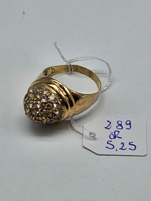 a gold ring with a diamond on it and a price tag