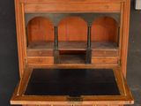 a small wooden desk with a marble top on it