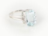 a close up of a ring with a blue topaz stone in it