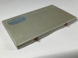 a metal box with a logo on it on a white surface