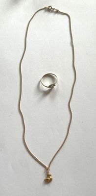 necklace, ring, and earring set on a white surface
