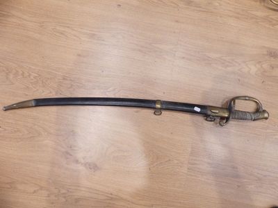 a sword that is on a table with a pair of scissors