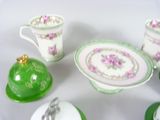 a table with a plate, cups and saucers on it