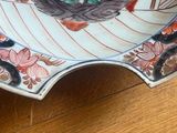 a plate with a design on it sitting on a wooden table