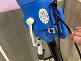 a person that is using a blue machine on the floor