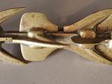 a close up of a metal hook on a white surface