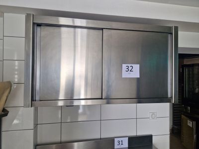 a stainless steel refrigerator in a kitchen with a number on it