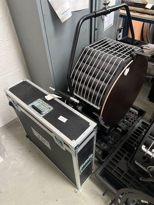 a black case sitting next to a stack of musical equipment