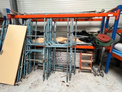 a pile of chairs in a room with a lot of shelves