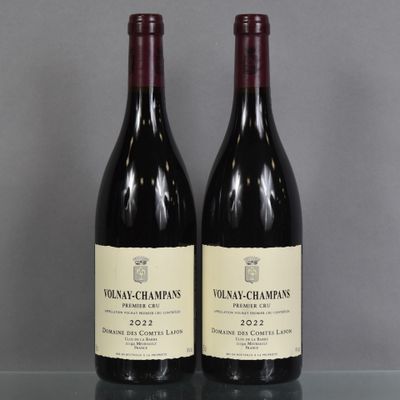 two bottles of wine sitting on top of a table next to each other
