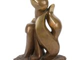 bronze sculpture of a woman and child sitting on a rock