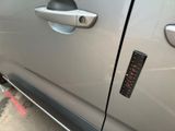 a close up of a car door handle with a sticker on it