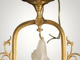 an image of a gold plate with a tassel hanging from it