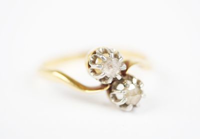 a close up of a diamond ring on a white surface
