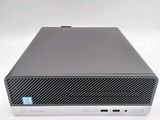 the back of a small computer with a keyboard on top of it