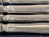 five silverware pieces in a box on a table