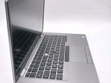 a silver laptop computer sitting on top of a white table