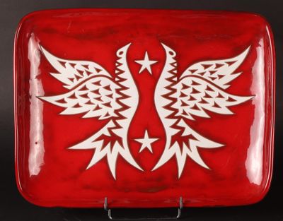 a red plate with a white bird design on it